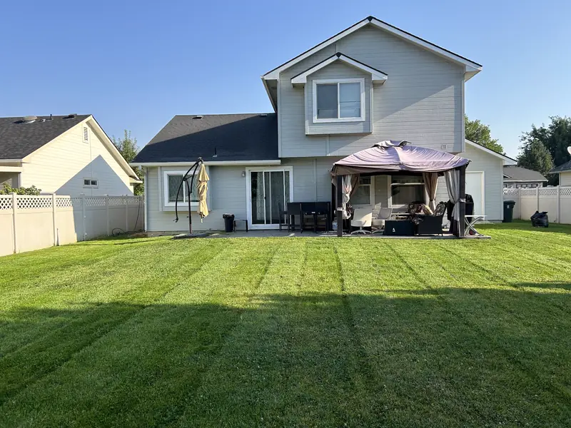 A backyard lawn mowed in stripes