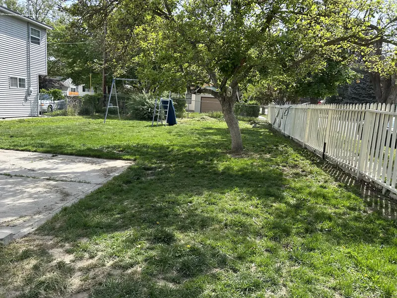 A cleaned up backyard with fresh cut grass